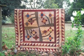 Jenny inspired me to show you the Ring Around the Posies Wallhanging I made from the large bed quilt pattern you see on the pattern page. Instructions for making this smaller version are in the pattern.